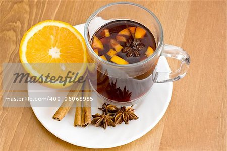 Christmas hot wine with oranges on wooden table