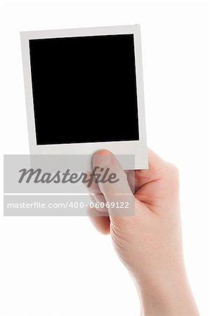 One instant photo in hand isolated on white background