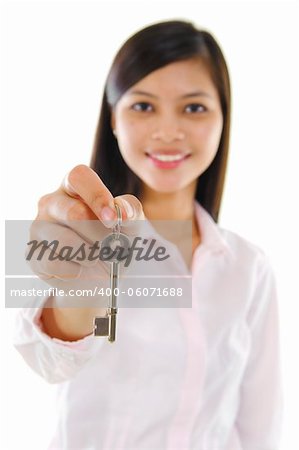 Mixed race sales woman holding key against white background.