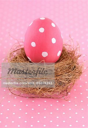 Painted pink Easter Egg in nest.