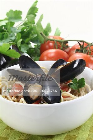 a bowl of spaghetti, mussels and tomato