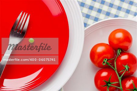 Directly above photograph of red tomatoes and a green pea.