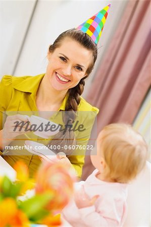 Mother drinking tea on babies birthday party