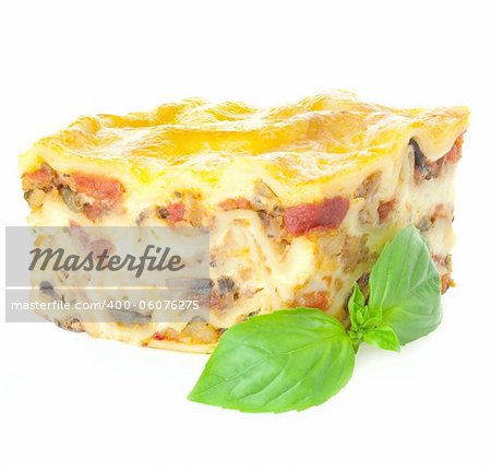 Home-baked hot Lasagne with fresh Basil / Isolated on white / Focus is all over