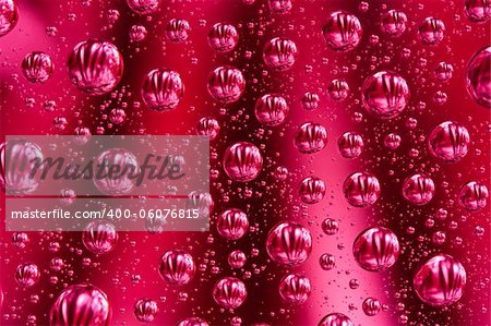 Abstract macro of water drops over red background