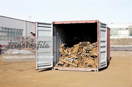 The scrap metal is in the open container