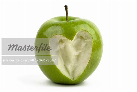 Green apple with a bite with a shape of a heart