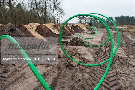 green fiber cable ready to go into the ground on a newly build industrial area