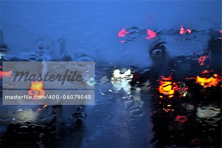 Rainy car windshield with shallow depth of field.