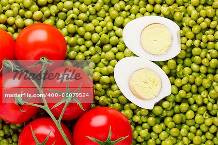 Directly above photograph of red tomatoes and green peas.