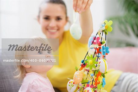 Mother showing baby Easter egg