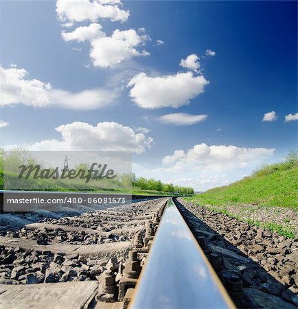 low angle view of railway under cloudy sky