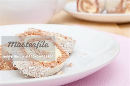 Swiss Sponge Roll Dessert With Cream on White Plate - Shallow Depth of Field