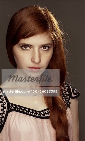 beautiful redhead girl with braided hair and freckles