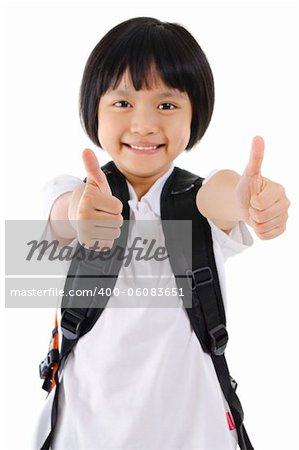 Thumbs up primary school girl with backpack on white background