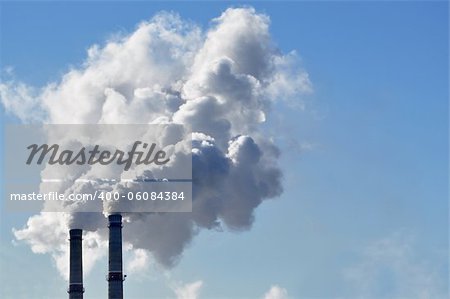 industrial smoke from chimney on blue sky