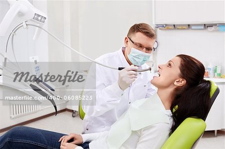 The dentist treats teeth of the patient in the clinic