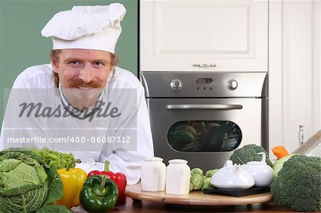 Young chef with vegetables, preparing lunch in kitchen