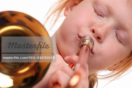 Young girl playing a trombone on white background