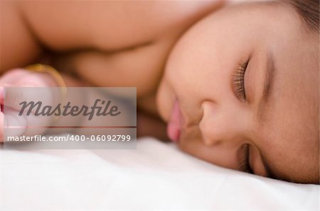 Adorable 6 months old Indian baby girl in deep sleep