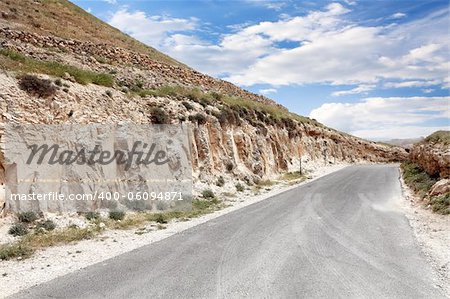 Mountain landscape with road and cloudy sky