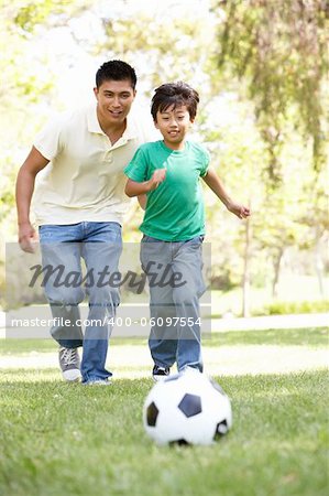 Father And Son In Park With Football