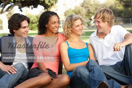 Group Of Teenagers Sitting In Playground