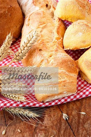 Food concept with Freshly baked bread variety on wooden background