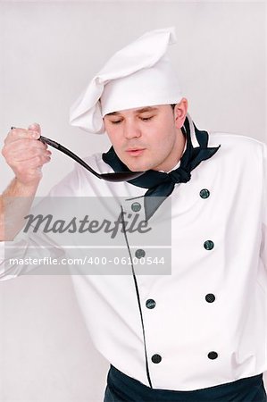 chef with large spoon on the gray background