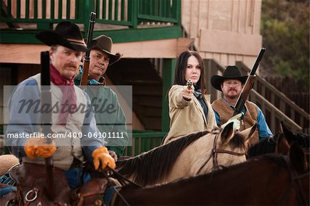 Old American west woman with pistol and 3 armed men