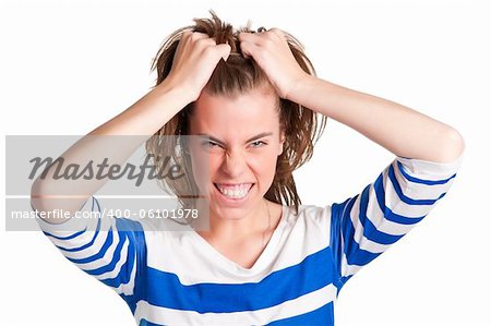 Frustrated and angry woman with hands in her hair pulling