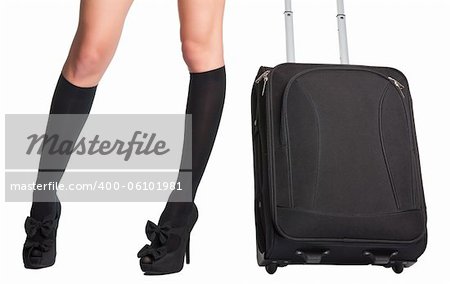 Businesswoman s legs in high stockings and high heels, holding a black suitcase