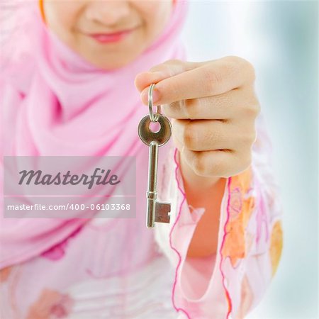 Muslim woman hand holding a new key