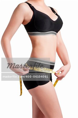 Woman measuring her waist with a yellow measuring tape