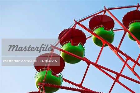 Detail of a green and red Ferris Wheel