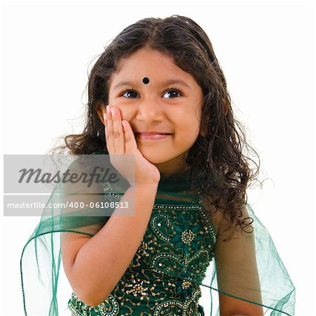 Thoughtful little Indian girl hand on chin , isolated white background