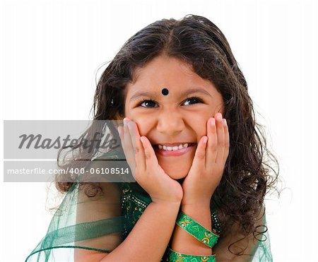 Young little Asian Indian girl smiling on white background