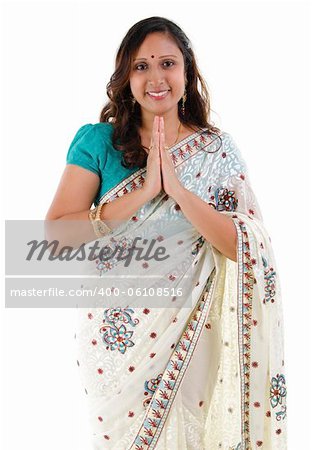 Mid Adult Indian woman in a greeting pose, isolated white background