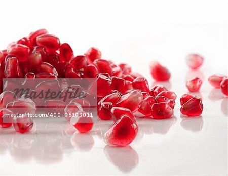 Ripe pomegranate seeds on white