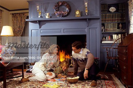 FAMILY SITTING BY FIREPLACE