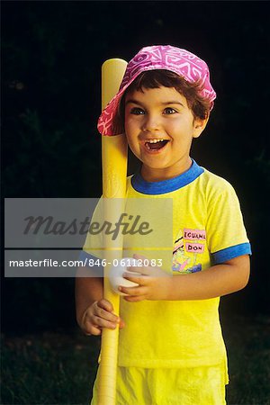 BOY IN PINK HAT HOLDING BALL AND PLASTIC BAT