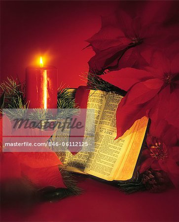 CHRISTMAS STILL LIFE RED CANDLE POINSETTIAS AND OPEN BIBLE