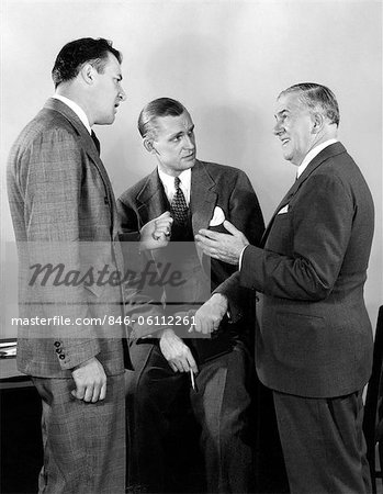 1930s 1940s THREE BUSINESSMEN SALESMEN HAVING A DISCUSSION IN OFFICE