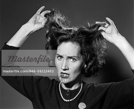 1960s WOMAN HAVING BAD HAIR DAY HOLDING HAIR PINS IN MOUTH FRUSTRATED