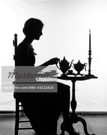 1920s SILHOUETTE OF WOMAN SITTING AT TABLE POURING CUP OF TEA