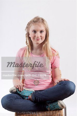 Smiling girl sitting cross legged