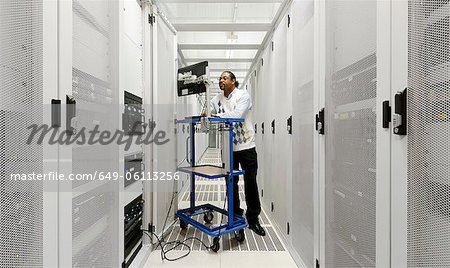Businessman using computer with servers