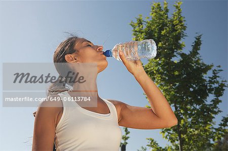 Woman drinking water outdoors