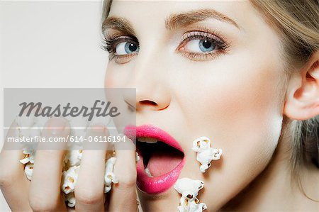 Young woman eating popcorn