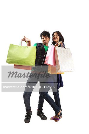 Young couple posing with shopping bags